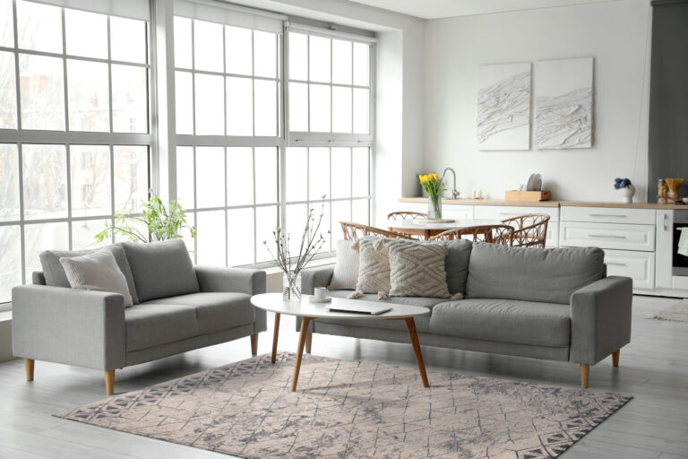 Interior,Of,Modern,Kitchen,With,Grey,Sofas,,Dining,Table,And